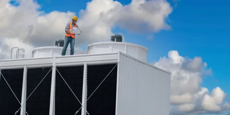 foto de torre de refrigeração com um trabalhador em inspeção